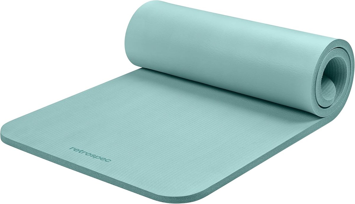 Retrospec Solana 1-inch yoga mat in Blue Ridge color, partially rolled on white background